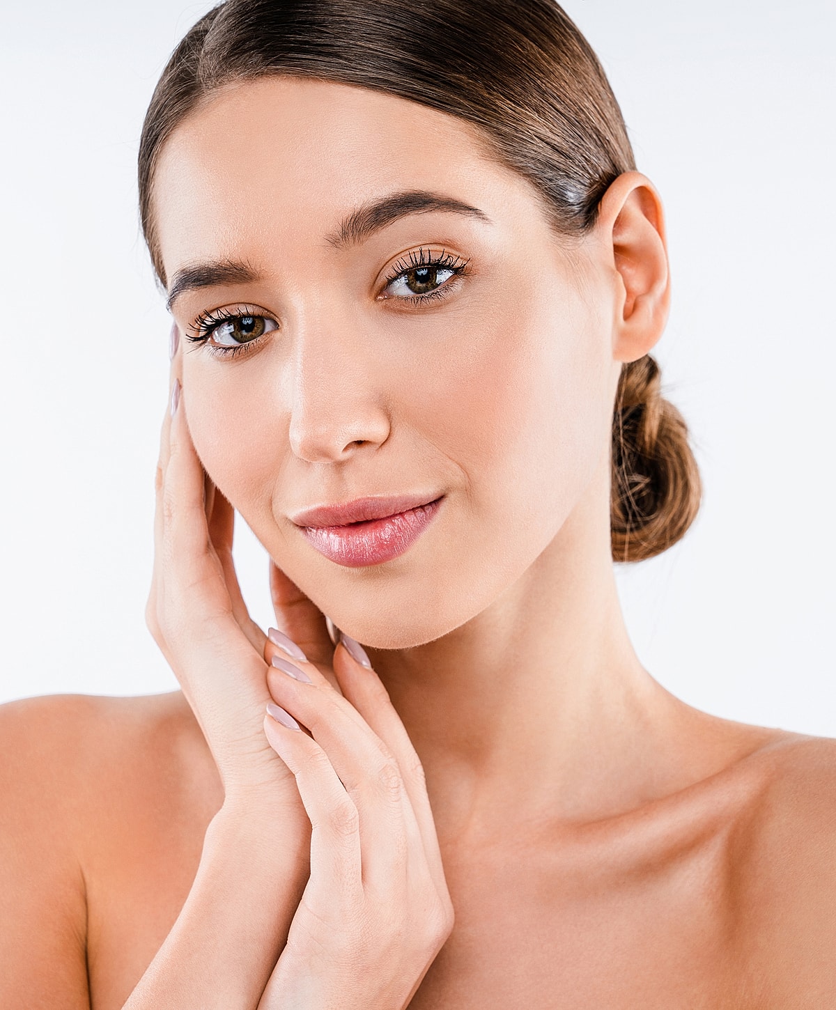 Woman gently touching her face, natural beauty.