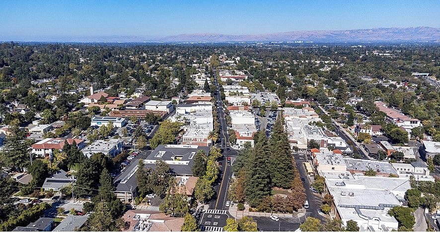 Aerial view of a suburban cityscape and greenery.