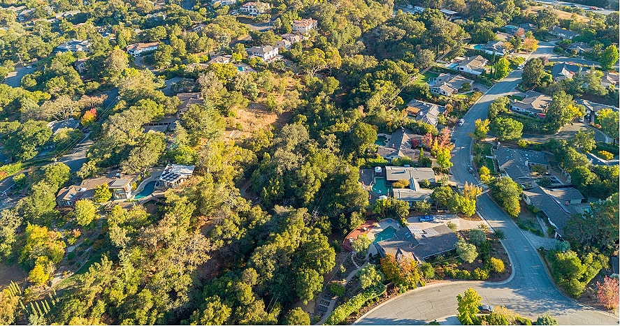 Aerial view of a suburban neighborhood with trees.