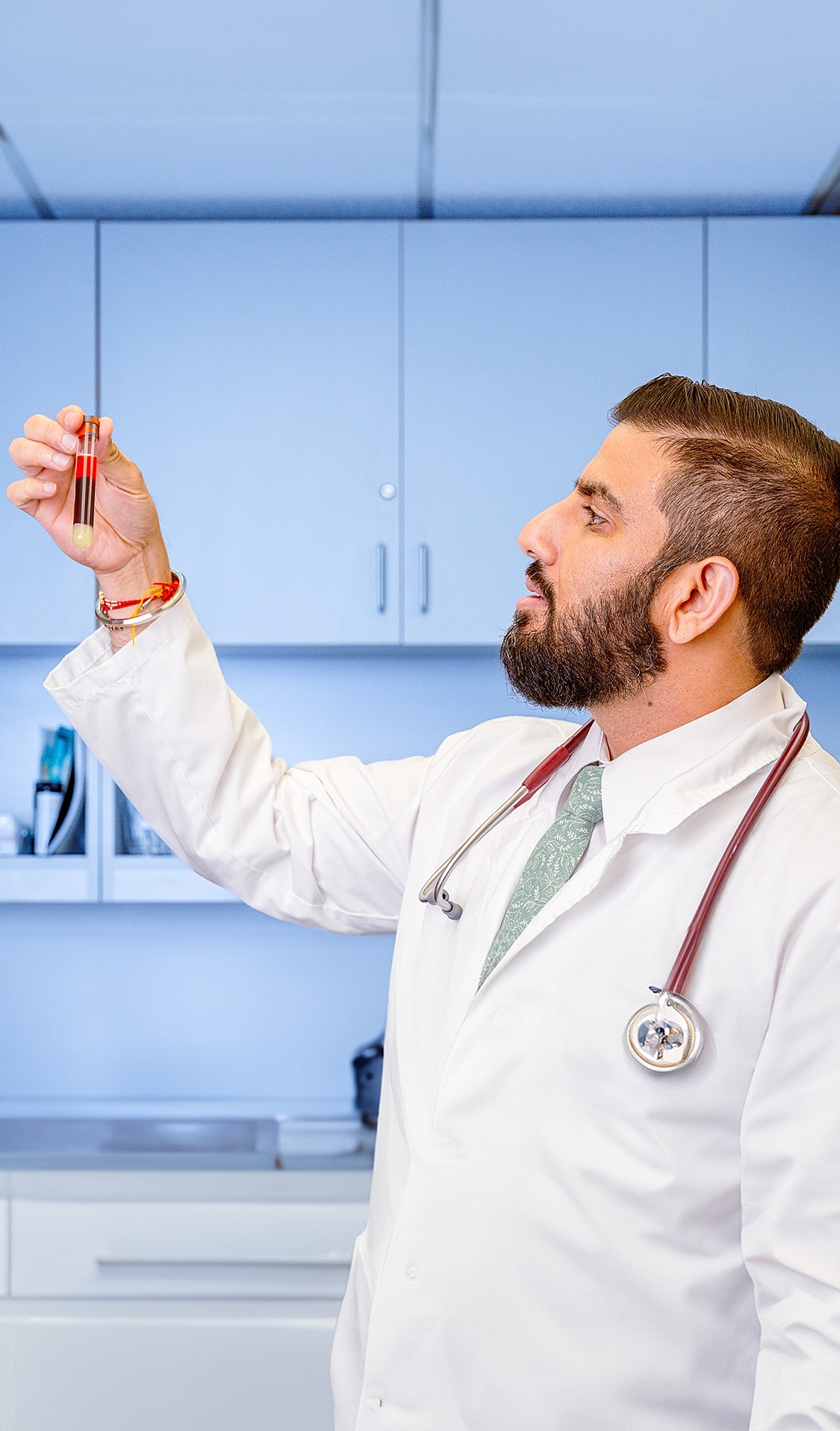 Doctor examining a blood sample in laboratory.