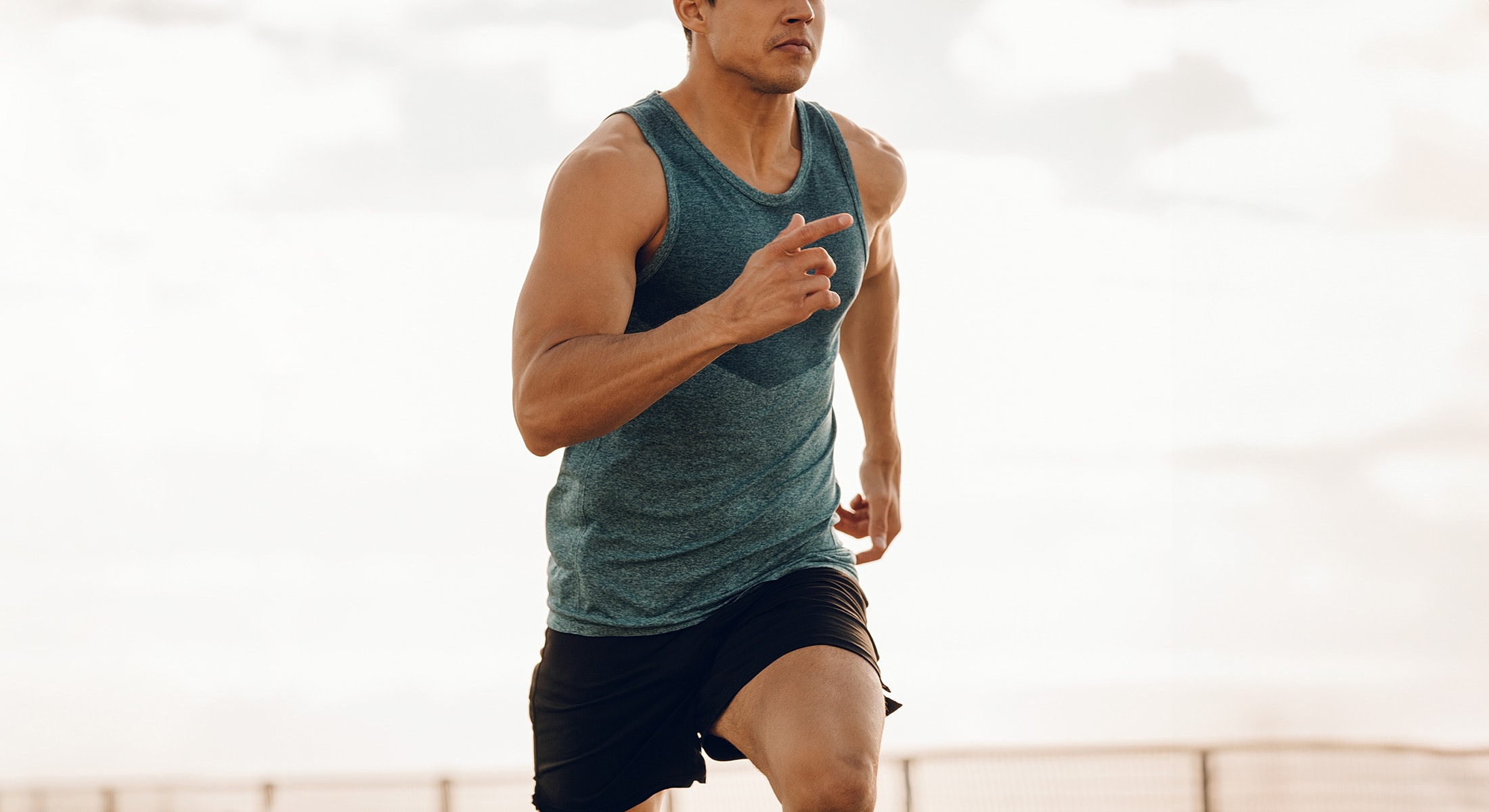 Man running outdoors in athletic attire.